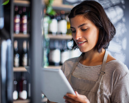 woman viewing vendor information on ipad | liquor store pos