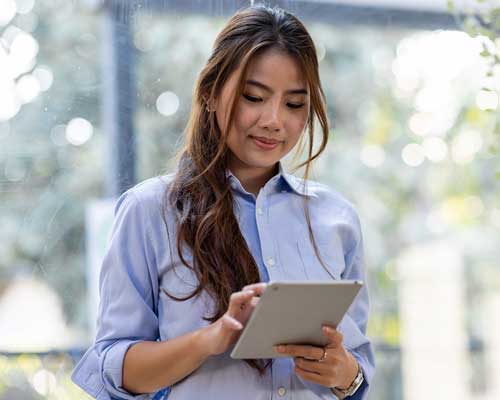 woman holding an ipad a familiar interface