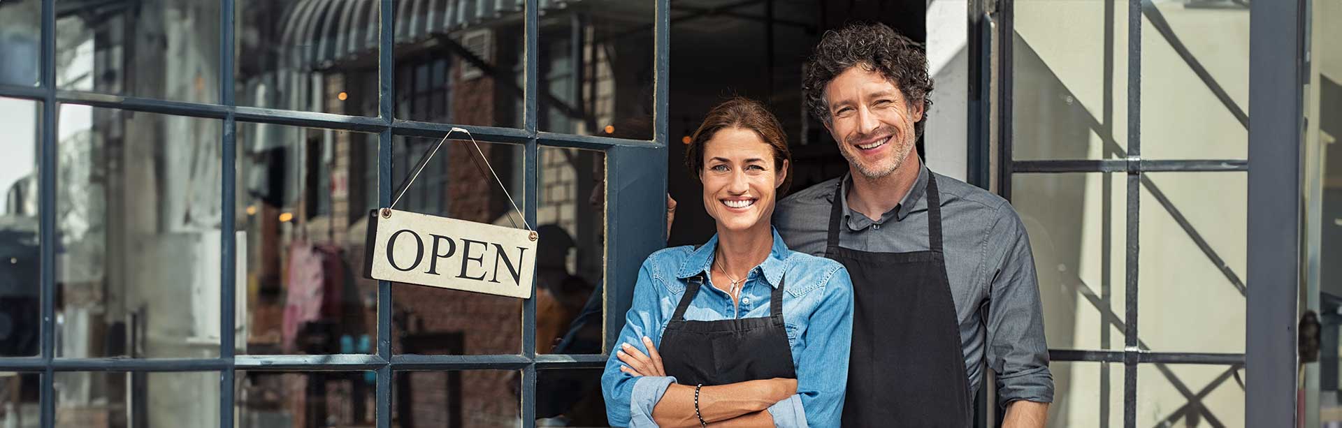 two business owners stand in front of their open sign | cash discount pos