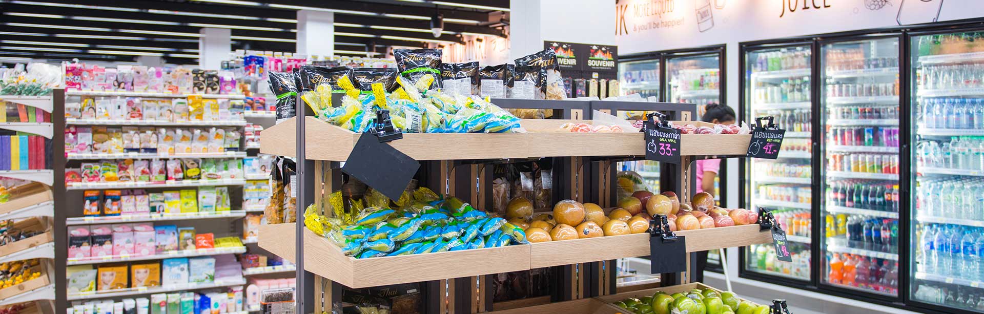 woman in a blue shirt standing in her retail shop | retail pos