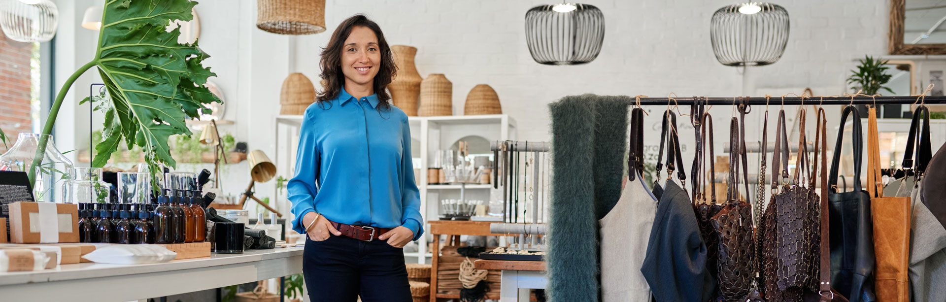 woman in a blue shirt standing in her retail shop | retail pos