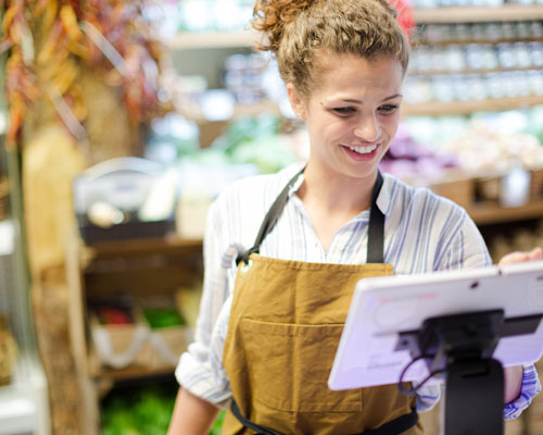 woman looking at ipad in store | convenience pos