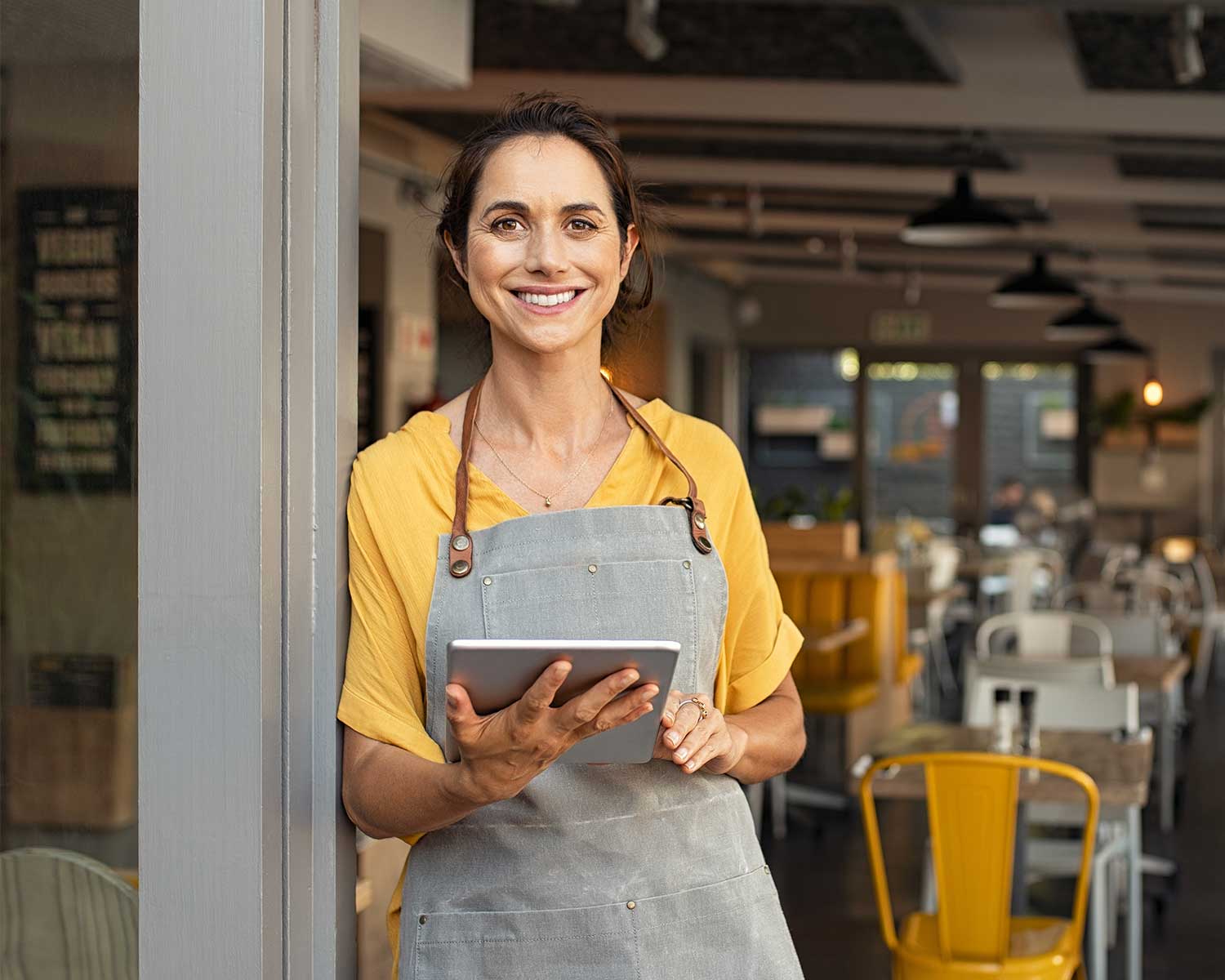 woman leans against door | ipad Point of Sale for restaurant